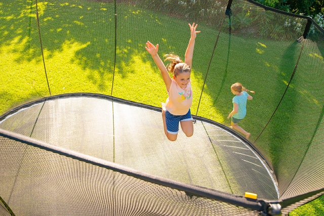 Load image into Gallery viewer, springfree trampoline girl jumping